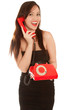 Beautiful woman with old red telephone talking