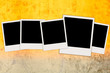 Five Blank Photos on Bright Concrete Wall