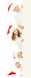 happy family in Christmas Santa's hats holding big banner for yo