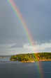 rainbow in rain during sunshine in Baltic sea rainbow in rain during sunshine in Baltic sea