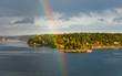 rainbow in rain during sunshine in Baltic sea rainbow in rain during sunshine in Baltic sea