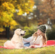Foto: Girl playing with her labrador retriever dog Girl playing with her labrador retriever dog
