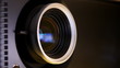 Front view of digital  film projector lens in action.