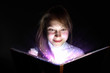 Young woman reading a magic book