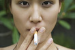 Young woman smoking outdoors