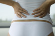 Woman experiencing lower back pain, cropped