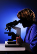 Student looking through a microscope