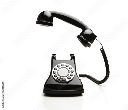 Photo: Old fashioned telephone on white background Old fashioned telephone on white background
