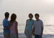 Two mature couples on beach at twilight