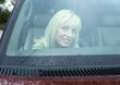 Woman in car, seen through windshield