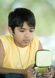 Preteen boy wearing earphones and holding case