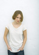 Teenage girl standing with hands in pockets, portrait