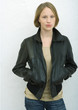 Teenage girl standing with hands in pockets, portrait