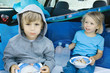 Children eating meal in back of car