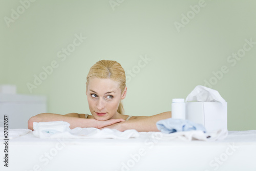 Photo: Woman in nursery, resting head on arms, looking away, smiling Woman in nursery, resting head on arms, looking away, smiling