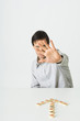 Photo: Man holding open palm toward camera, Chinese chess pieces in shape of arrow pointing to him Man holding open palm toward camera, Chinese chess pieces in shape of arrow pointing to him