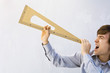 Man pretending triangular measuring instrument is a megaphone, shouting with eyes closed