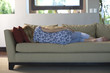 Young woman napping on sofa, rear view