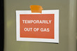 Sign at gas station reading Temporarily out of gas""