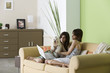 Woman relaxing with pet dog and teenage daughter