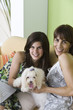 Mother and teen daughter with pet dog, portrait