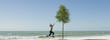 Boy jumping in midair on beach