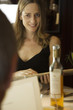 Mature woman looking at menu with companion in restaurant