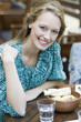 Young woman at restaurant, portrait