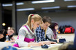 pretty female college student sitting in a classroom