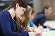 Photo: pretty female college student sitting in a classroom pretty female college student sitting in a classroom