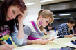 pretty female college student sitting in a classroom pretty female college student sitting in a classroom