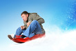 Young man flies on sled in the snow, concept
