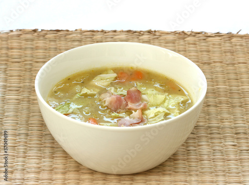 Photo: Vegetable cabbage soup in white bowl with bacon pieces Vegetable cabbage soup in white bowl with bacon pieces