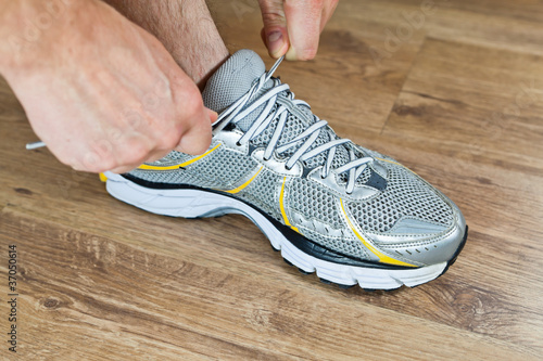 Photo: Sport shoe tying, exercise at gym Sport shoe tying, exercise at gym
