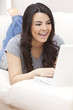 Happy Hispanic Woman Using Laptop Computer
