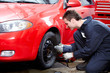 Auto mechanic changing a tire.