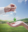 Man is handing a house key to a woman