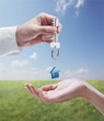 Man is handing a house key to a woman