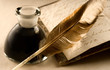 An old book with a feather and the inkpot full of ink
