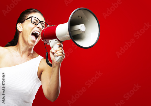 Photo: woman shouting using megaphone woman shouting using megaphone