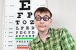 person wearing spectacles in an office at the doctor