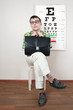 person wearing spectacles in an office at the doctor