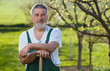 portrait of a senior man gardening in his garden