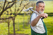 portrait of a senior man gardening in his garden