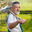portrait of a senior man gardening in his garden