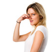 Blonde woman pinching her nose