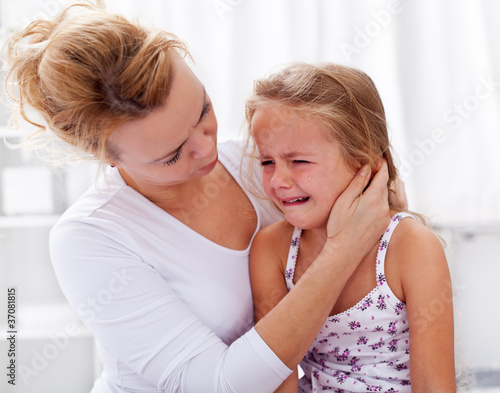 Photo: Mother comforting her crying little girl Mother comforting her crying little girl