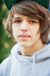 Close up of a teenage boy outdoors . Close up of a teenage boy outdoors .