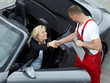 Master mechanic and customer shaking hands outdoors