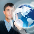 Portrait of handsome young man touching virtual globe. Global ne